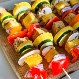 a row of ungrilled vegetables on a wooden tray by Jackfruitful Kitchen, Grilled Veggie Skewers